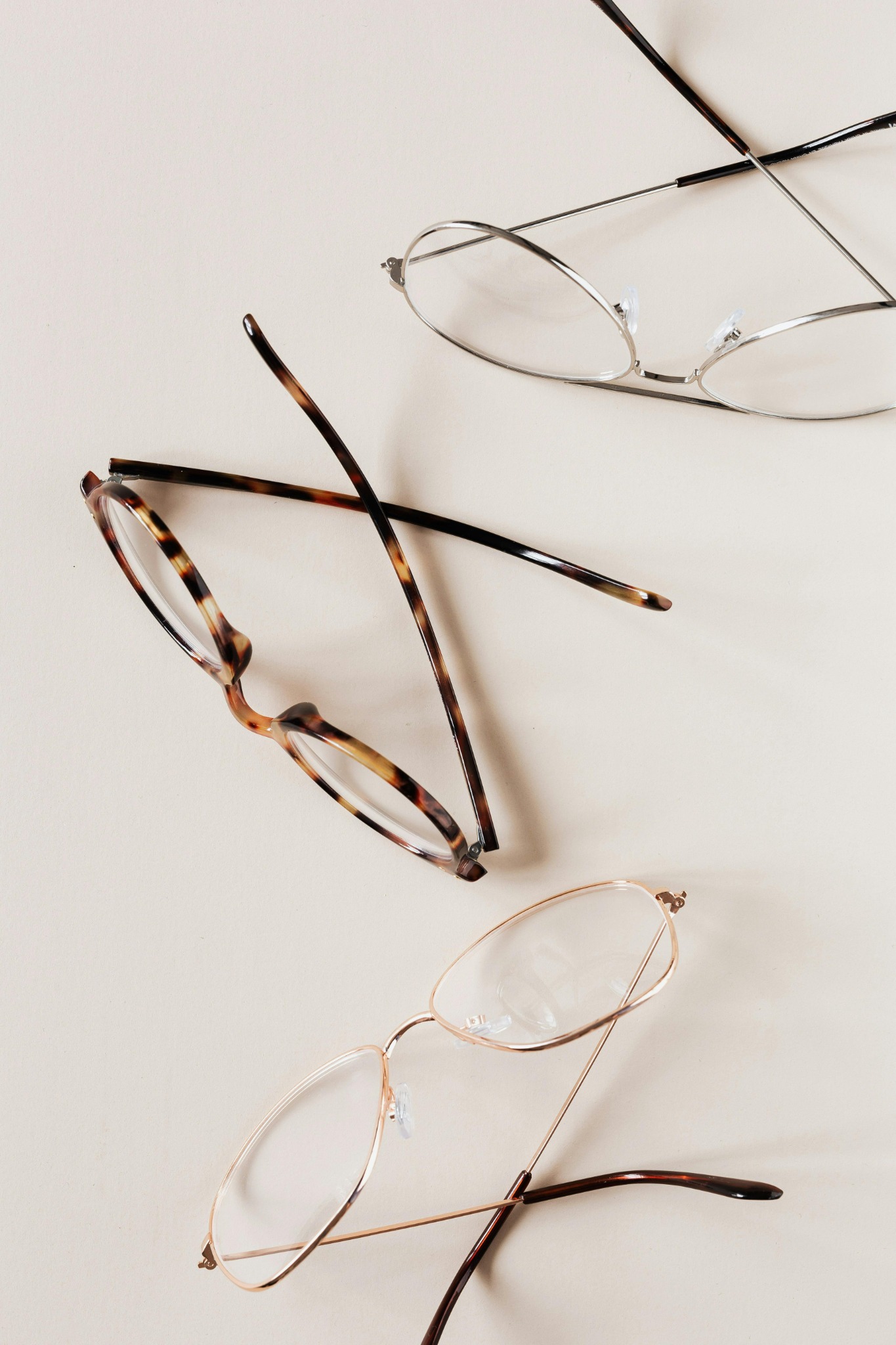 Collection of eyeglasses on beige background
