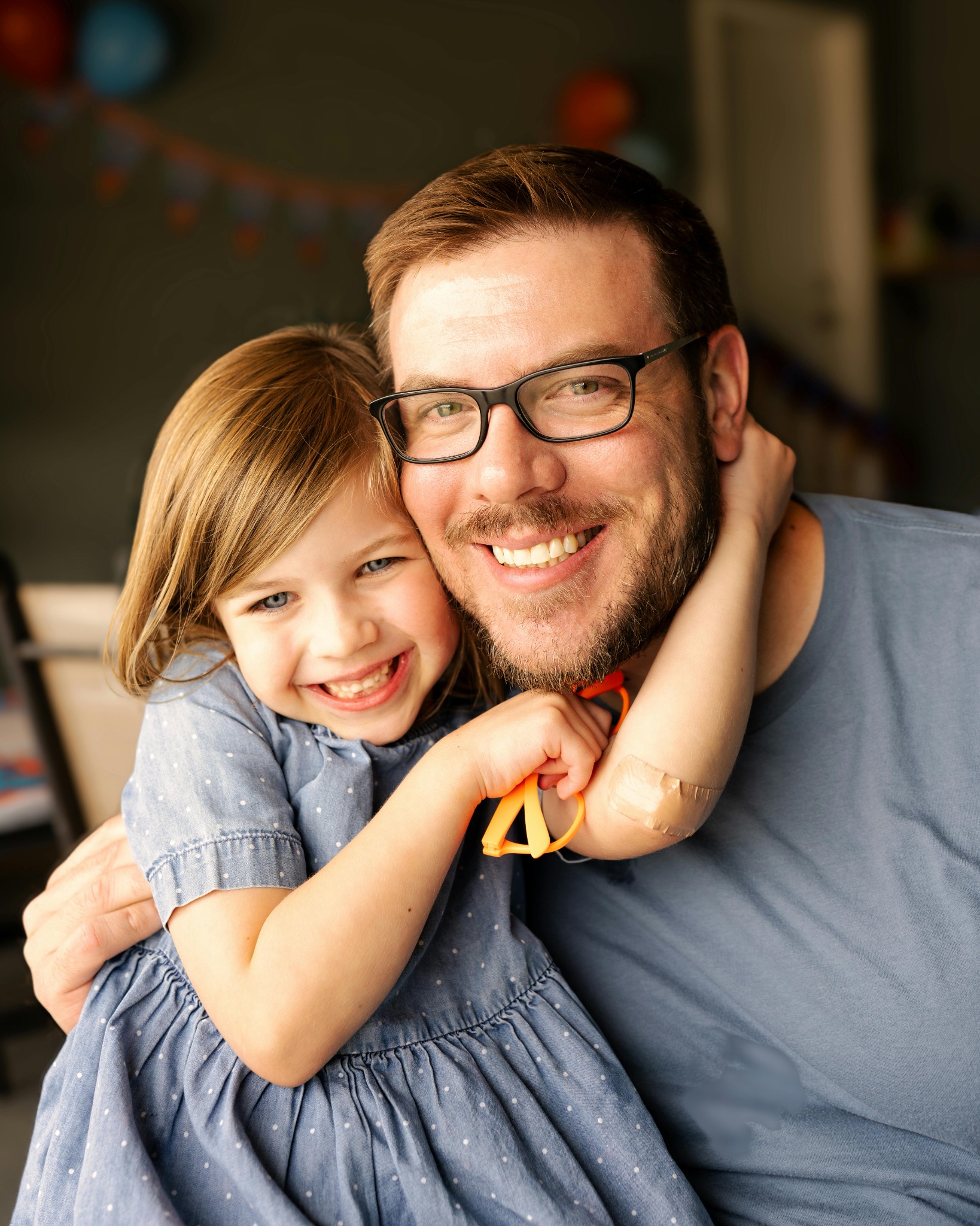 Father and daughter smiling in glasses