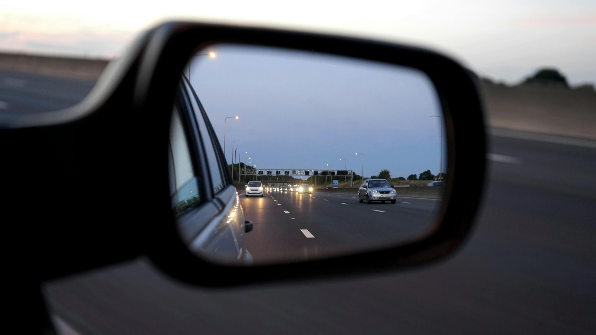 Driver’s view through a car mirror with glasses