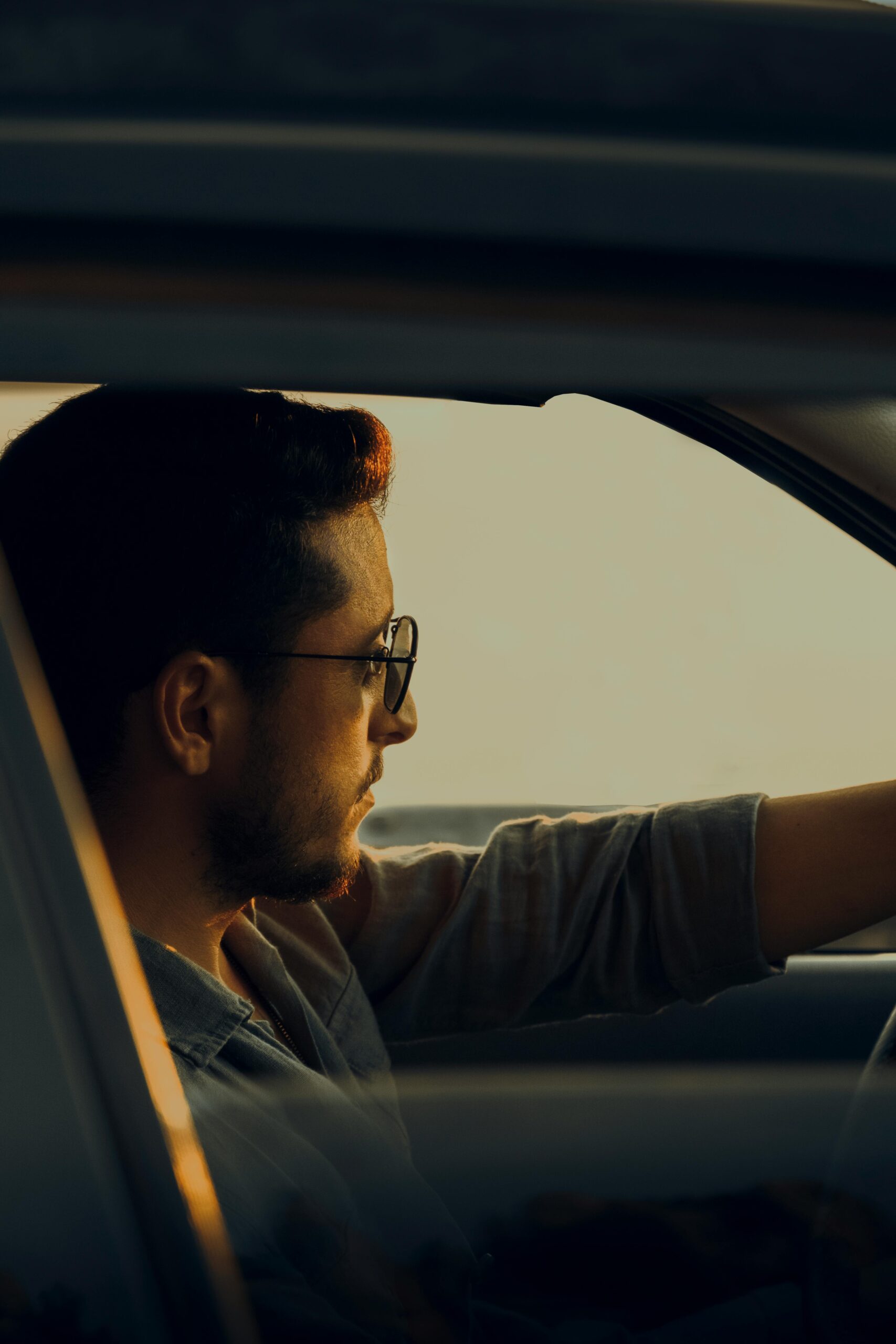 Man wearing sunglasses while driving – lifestyle driving eyewear in the UK