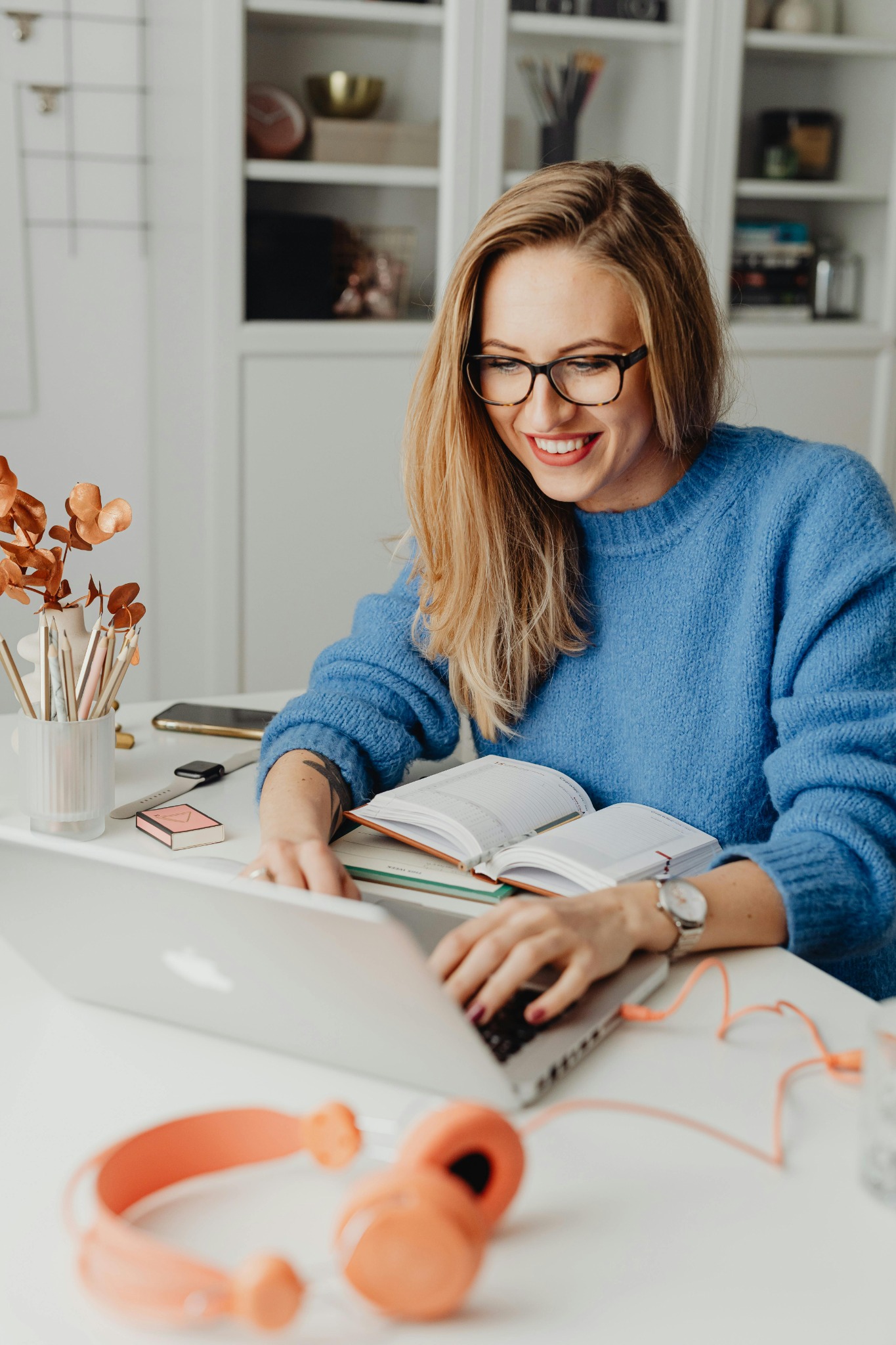 Woman wearing glasses while working on laptop – UK blue light checker
