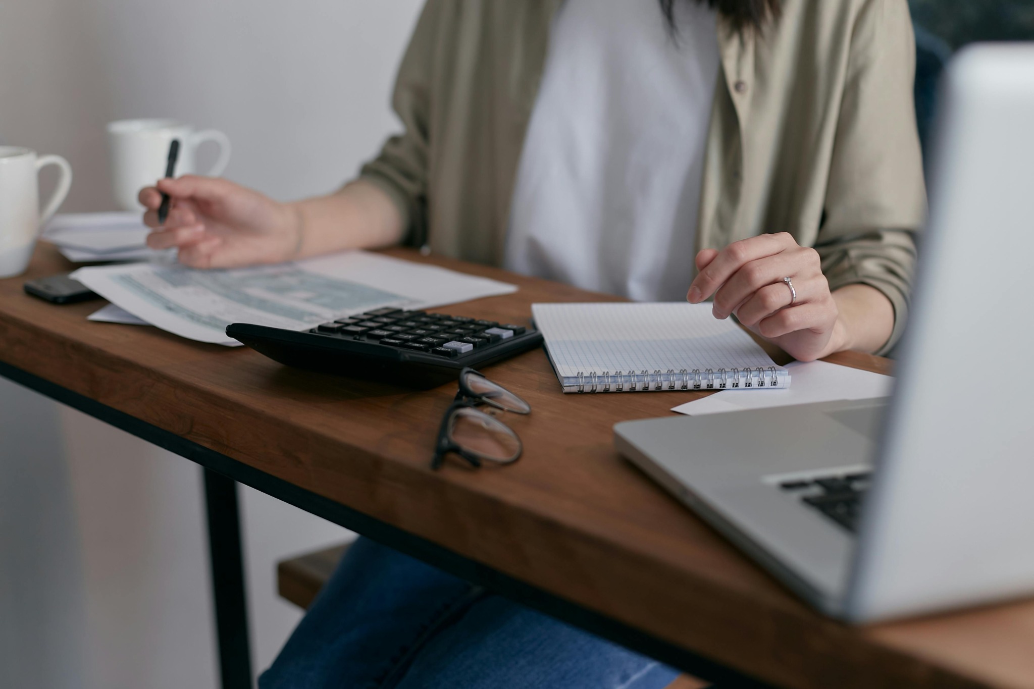 Working desk with glasses and calculator